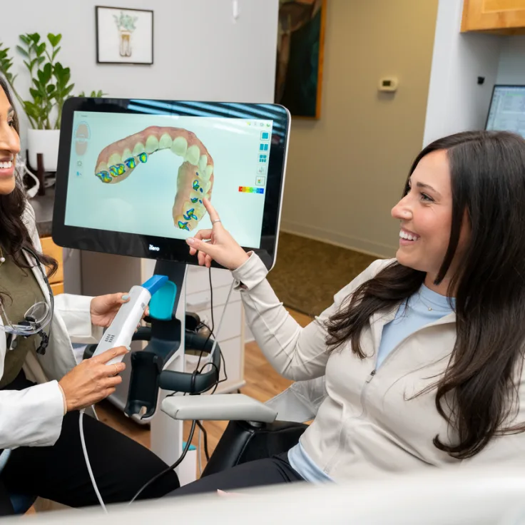 Patient reviewing a digital clear aligner scan at Lumon Dental